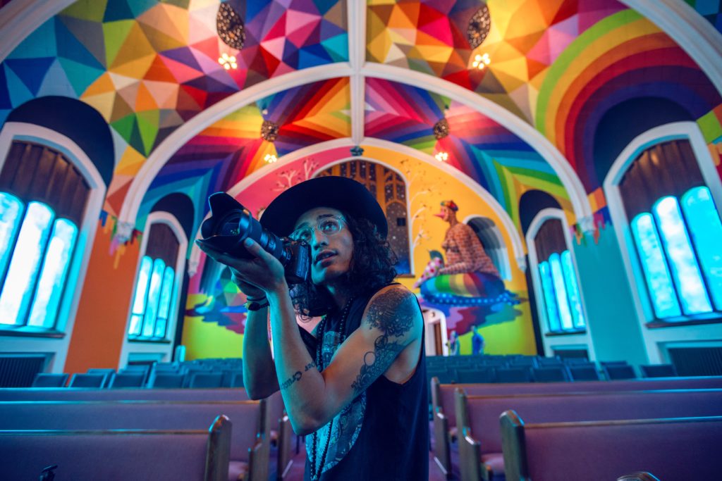 Photographer in colorful church.